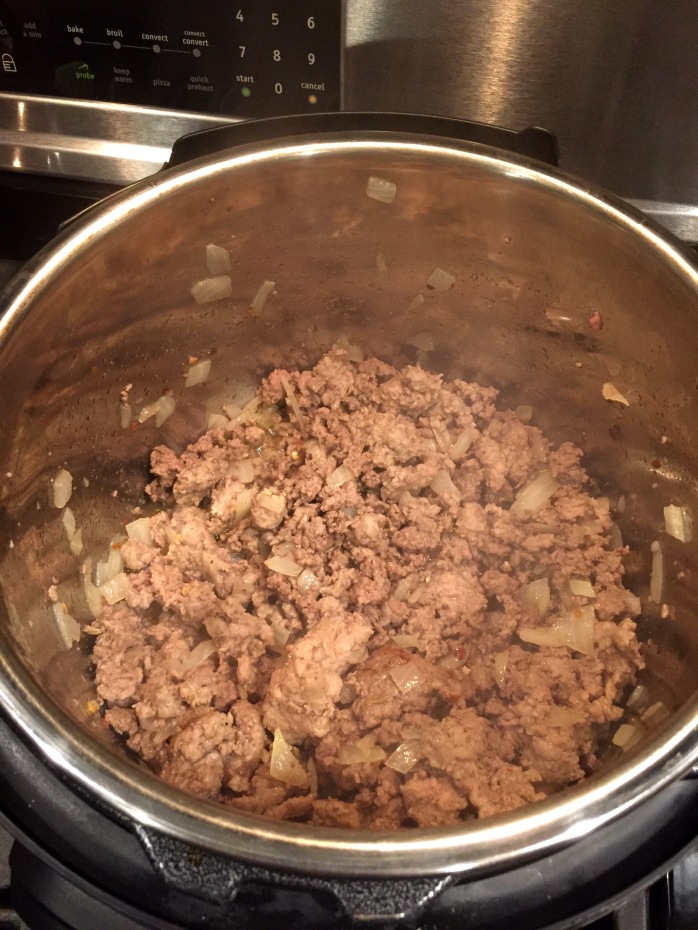 Brown the sausage, ground beef, and onion on the saute setting. I like to place my Instant Pot on top of the stove under the fan. Then move it to the counter for the remainder of cooking time. 